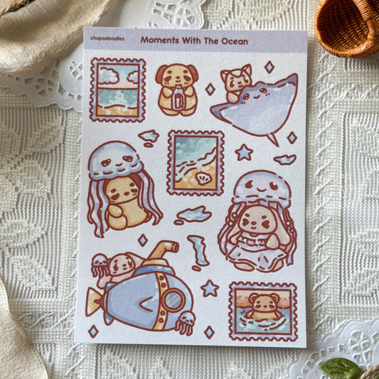 Sheet of cute animal-themed stickers with 'Moments With The Ocean' text on a textured surface.