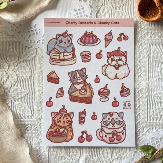 Sheet of stickers featuring cats and desserts on a textured surface