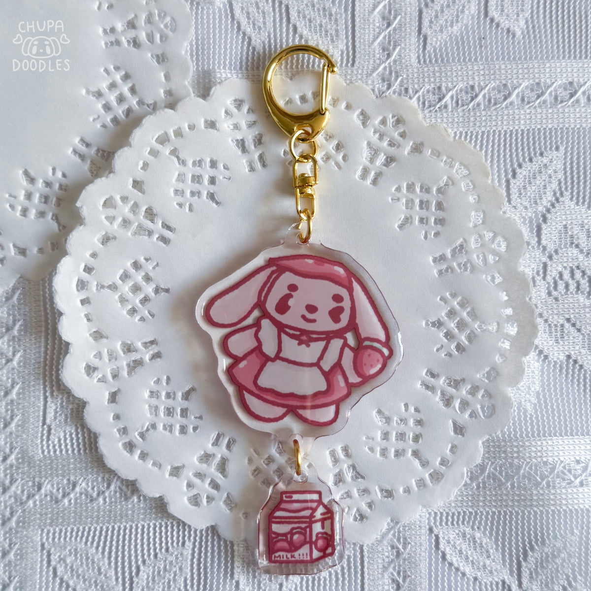Bun Bun epoxy keychain styled on a bag, two charms on a gold-tone clasp