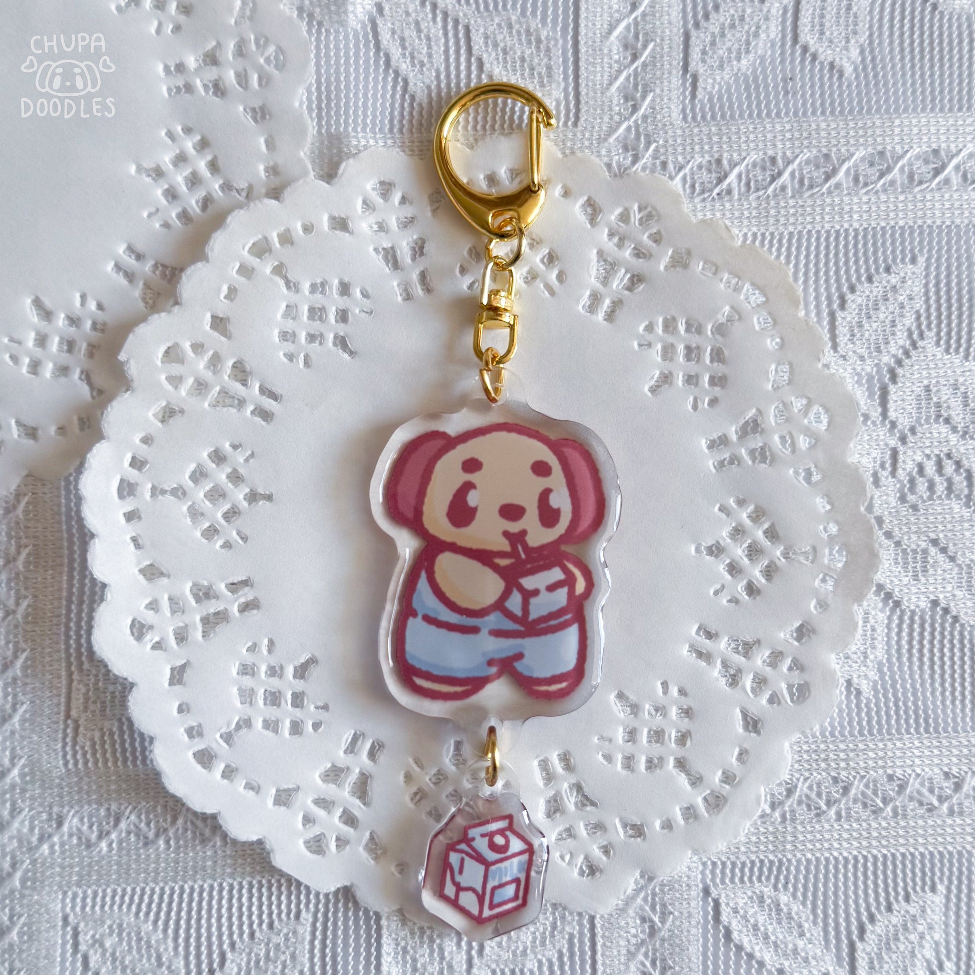 Chupa epoxy keychain with size reference, two charms on a gold-tone clasp