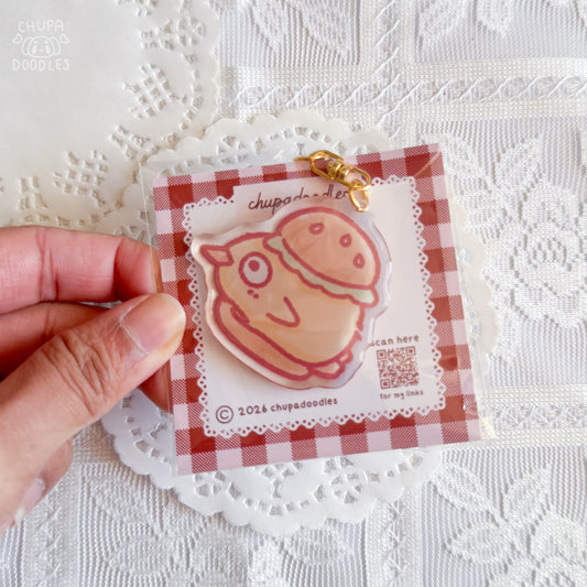 Duck in a burger epoxy keychain close up, glossy double-sided charm