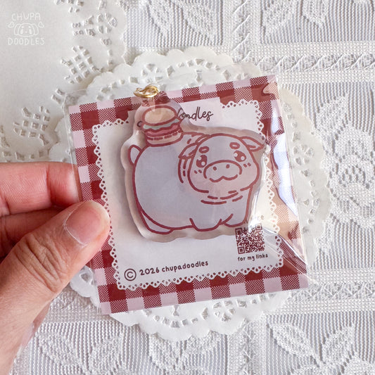 Moo Deng epoxy keychain close up, glossy double-sided charm